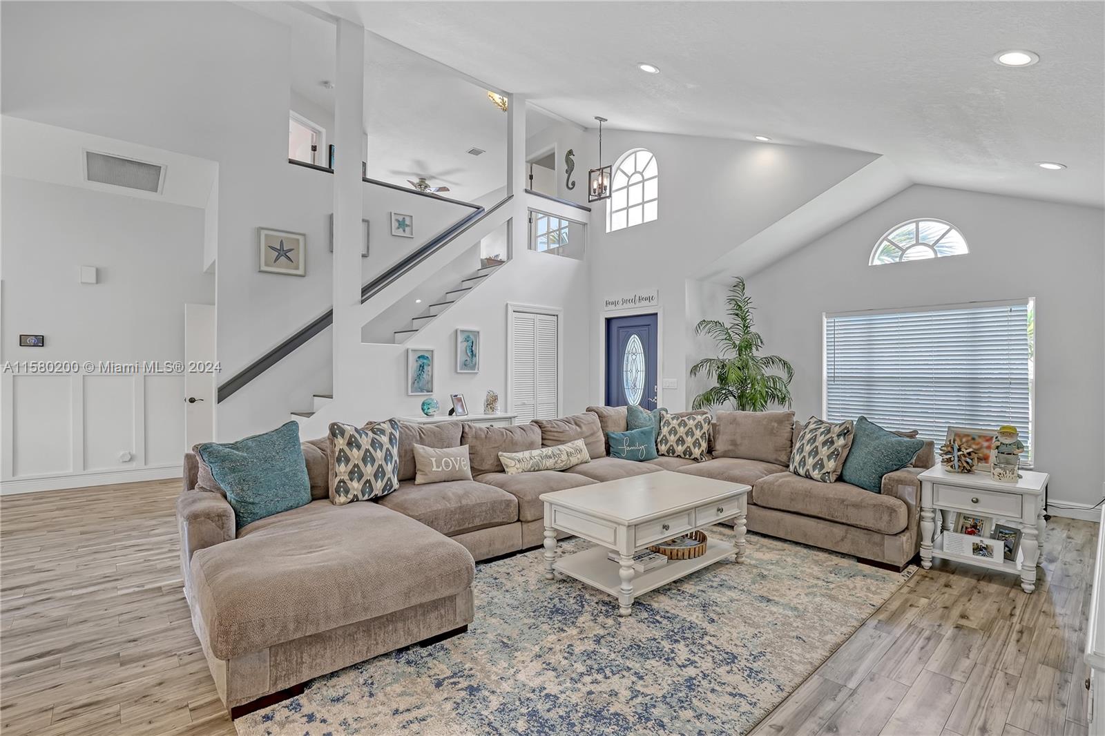 147 Stonebriar Boulevard Jupiter, FL 33458 - Photo 7 of 39 a living room with furniture and wooden floor