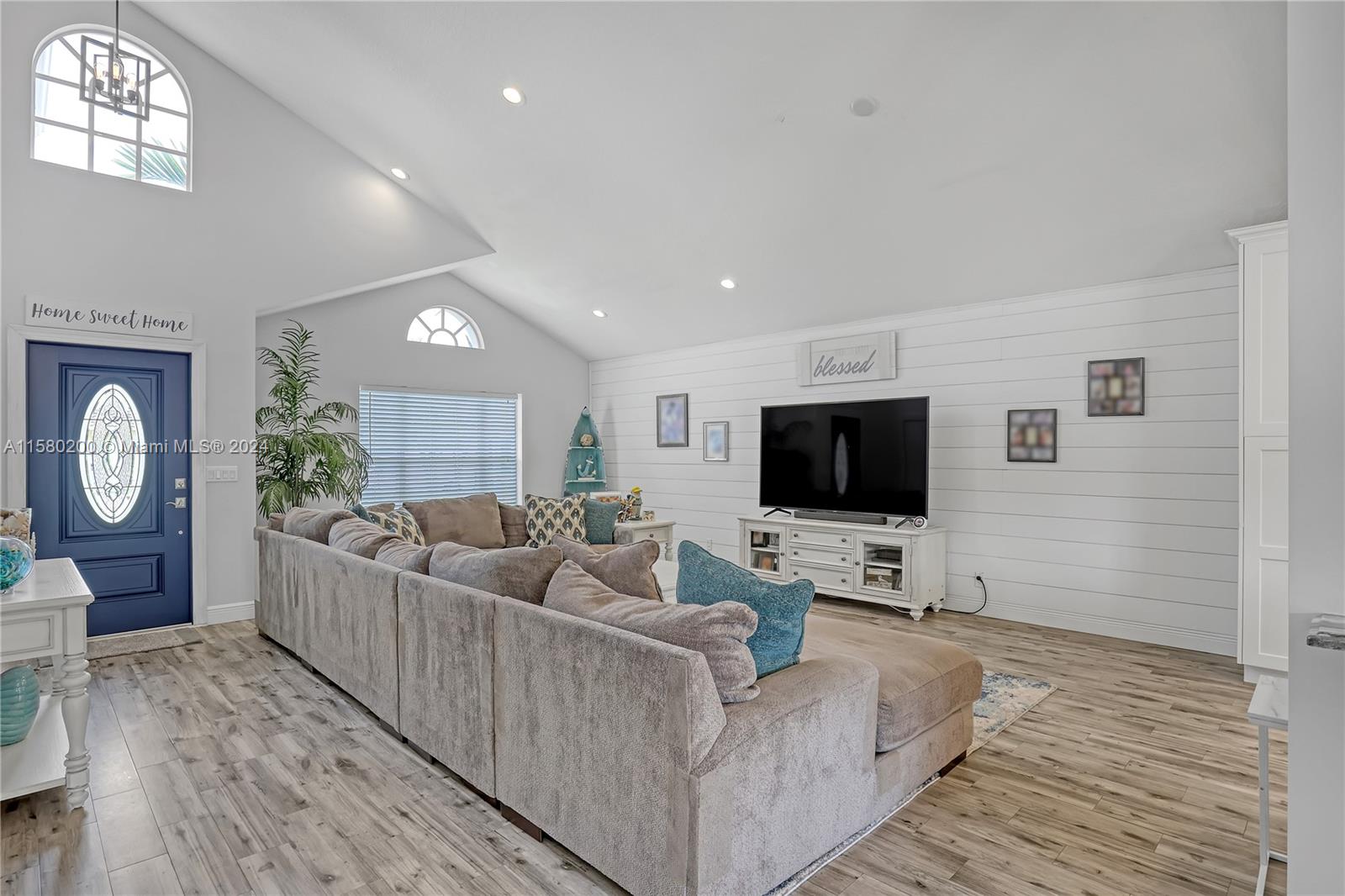 147 Stonebriar Boulevard Jupiter, FL 33458 - Photo 9 of 39 a living room with furniture and a flat screen tv