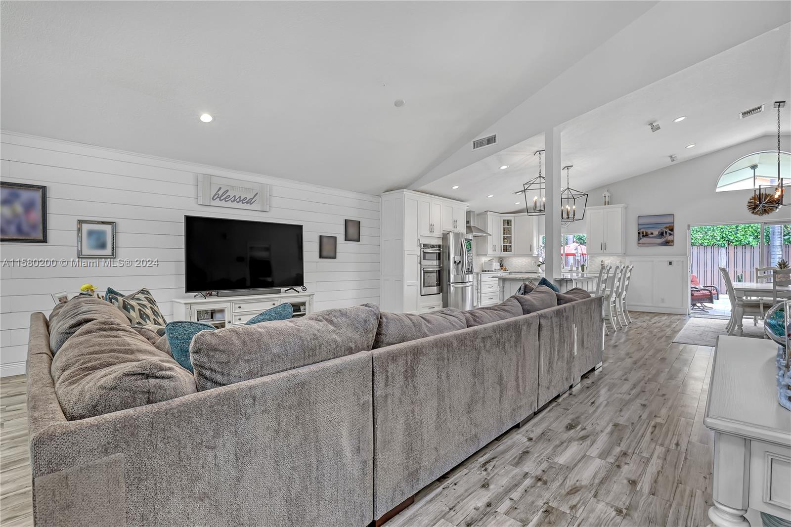 147 Stonebriar Boulevard Jupiter, FL 33458 - Photo 10 of 39 a living room with furniture and a flat screen tv