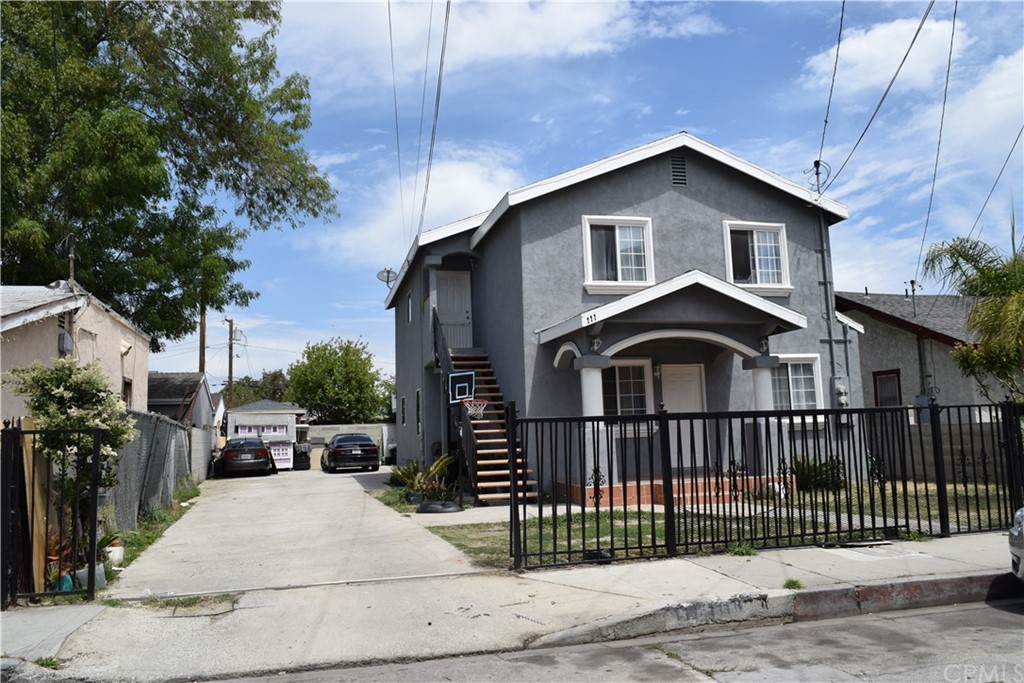 111 East Cedar Street Compton, CA 90220 - Photo 4 of 7 a view of a house with a small yard and plants