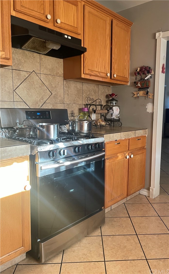111 East Cedar Street Compton, CA 90220 - Photo 5 of 7 a kitchen with stainless steel appliances granite countertop a sink stove and cabinets