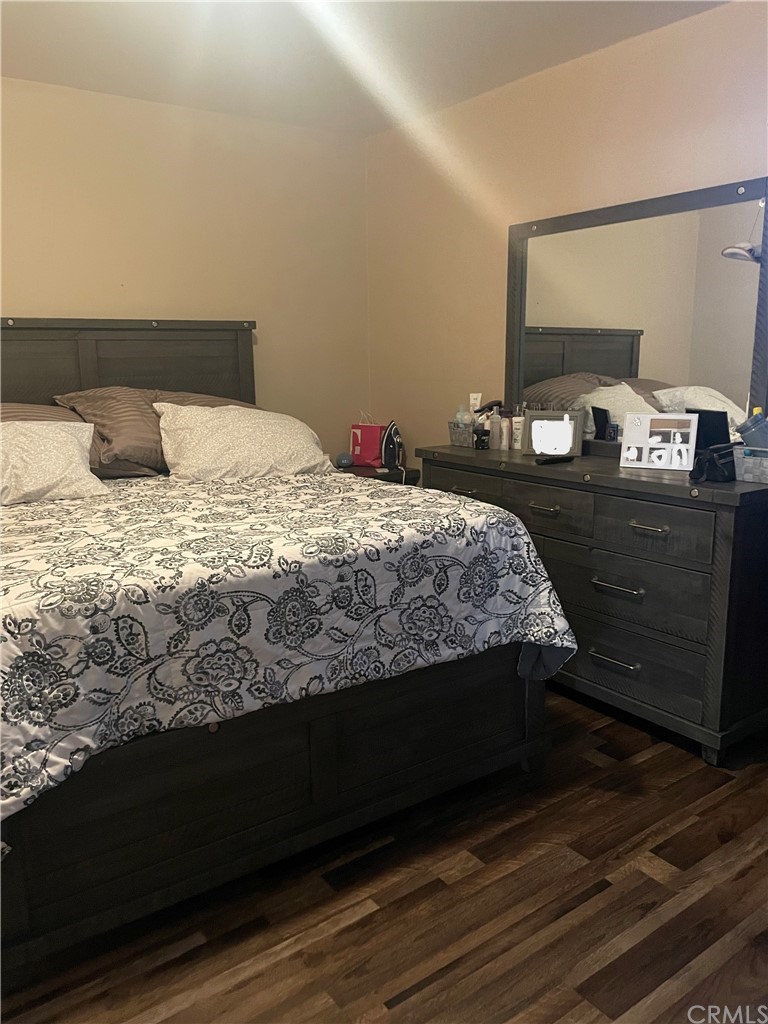 111 East Cedar Street Compton, CA 90220 - Photo 7 of 7 a bedroom with a bed and wooden floor