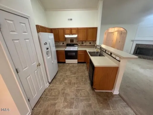 a kitchen with stainless steel appliances a stove a sink and a refrigerator