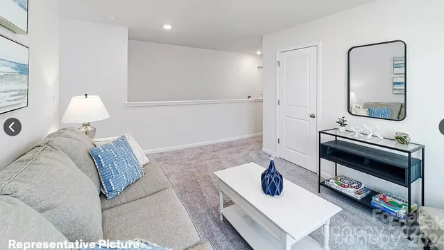 a bedroom with furniture and a mirror