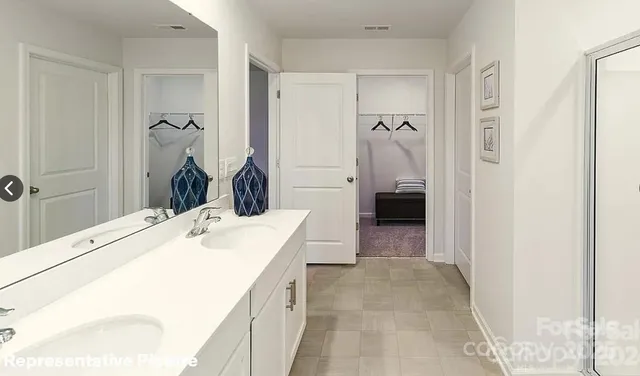 a en suite bathroom with a sink and a shower