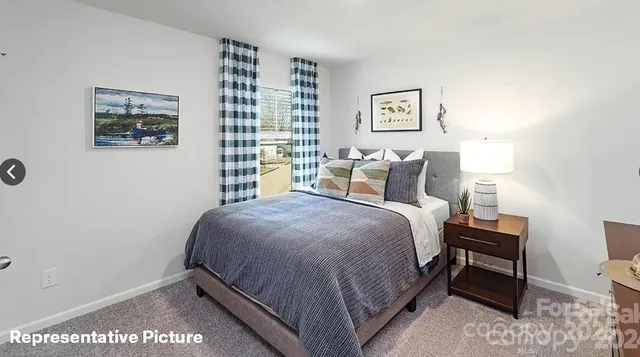 a bedroom with a bed and a night stand