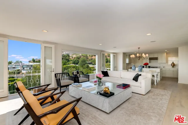 a living room with furniture and a floor to ceiling window