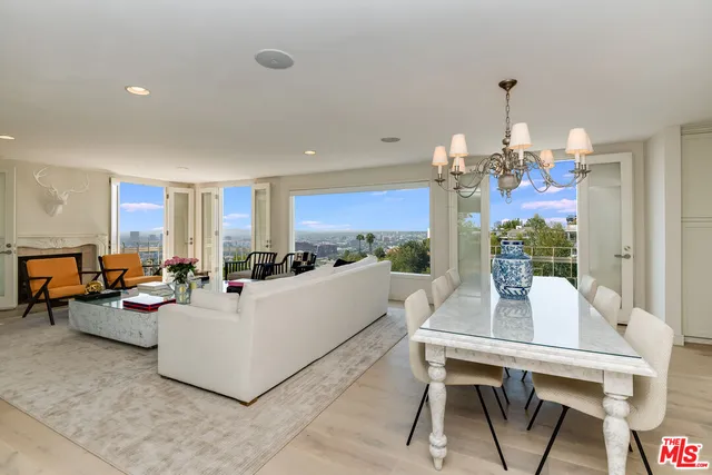 a living room with fireplace furniture and a chandelier