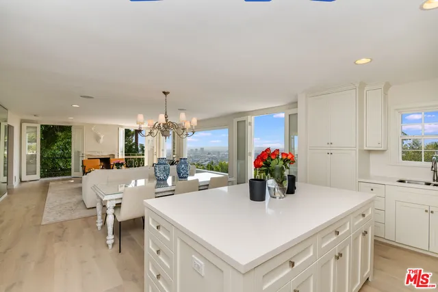 a kitchen with a sink and white cabinets