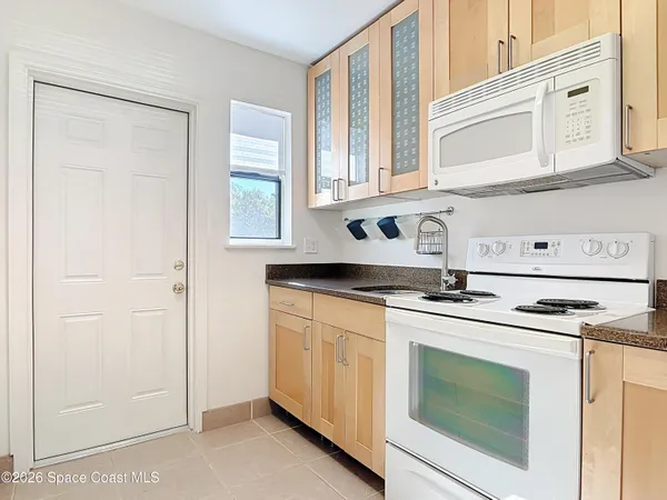 a kitchen with stainless steel appliances granite countertop white cabinets and a sink