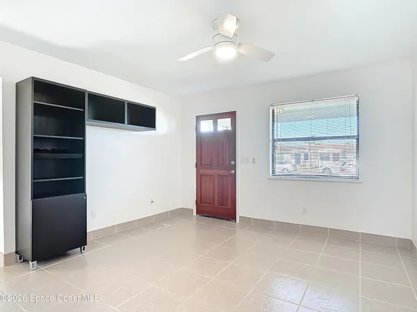 a view of an empty room with a cabinet