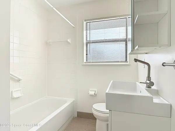 a bathroom with a sink toilet and bathtub