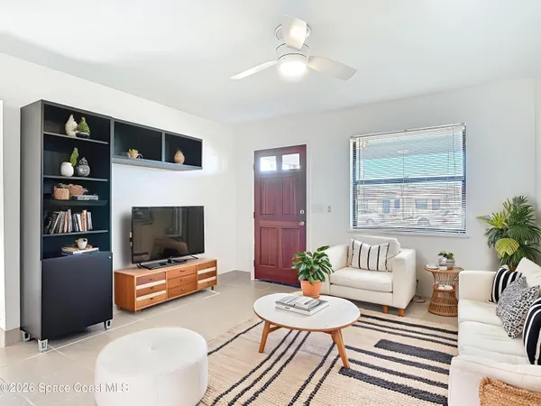 a living room with furniture and a flat screen tv