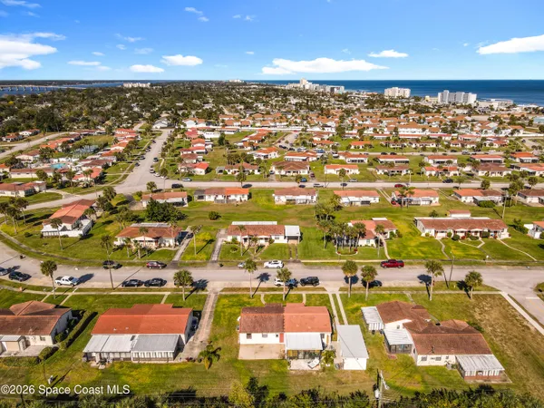 an aerial view of residential houses with outdoor space