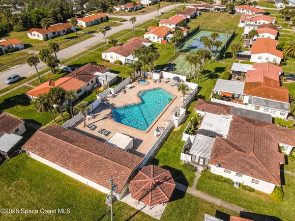 an aerial view of residential houses with outdoor space