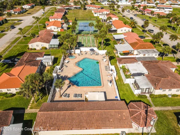 an aerial view of residential houses with yard