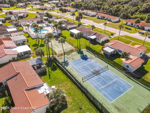 an aerial view of residential houses with outdoor space
