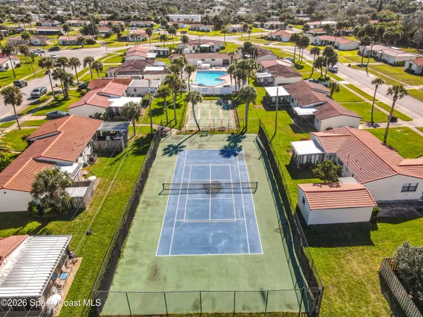 an aerial view of residential houses with yard