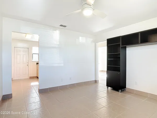 an empty room with closet and a bathroom