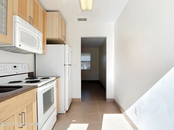 a view of a kitchen with electric appliances