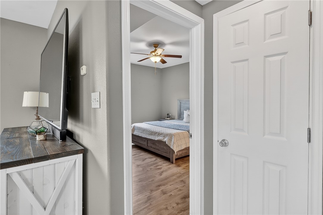 14427 Compass Street, Unit A6 Corpus Christi, TX 78418 - Photo 11 of 40 a view of a bedroom with a bed and ceiling fan