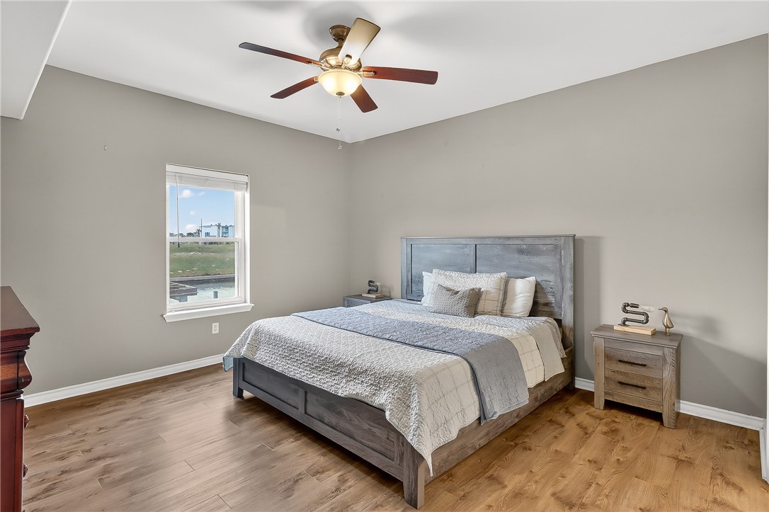 14427 Compass Street, Unit A6 Corpus Christi, TX 78418 - Photo 12 of 40 a bedroom with a bed chandelier and a window