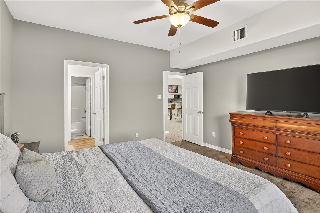 14427 Compass Street, Unit A6 Corpus Christi, TX 78418 - Photo 14 of 40 a bedroom with a bed and a flat screen tv