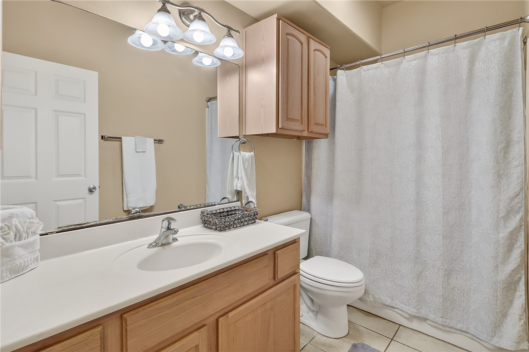 14427 Compass Street, Unit A6 Corpus Christi, TX 78418 - Photo 25 of 40 a bathroom with a toilet a sink and a mirror