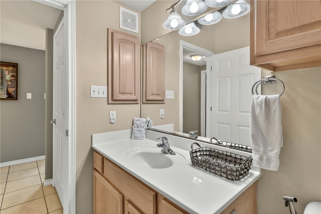 14427 Compass Street, Unit A6 Corpus Christi, TX 78418 - Photo 26 of 40 a bathroom with a sink and a mirror