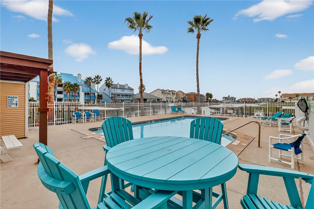 14427 Compass Street, Unit A6 Corpus Christi, TX 78418 - Photo 31 of 40 a view of a balcony with table and chairs