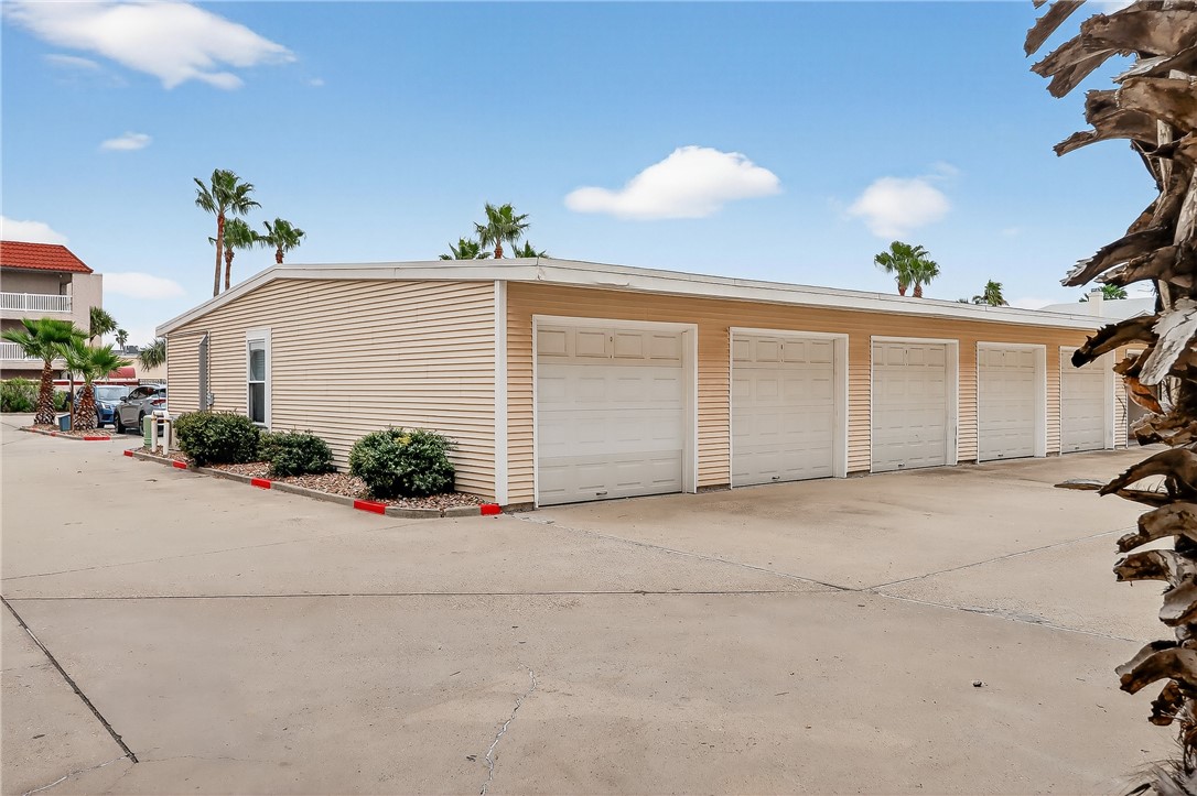 14427 Compass Street, Unit A6 Corpus Christi, TX 78418 - Photo 35 of 40 a view of a house with a yard and garage