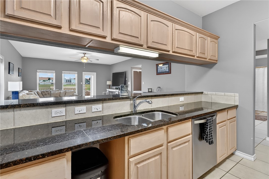 14427 Compass Street, Unit A6 Corpus Christi, TX 78418 - Photo 8 of 40 a kitchen with stainless steel appliances granite countertop a sink and cabinets
