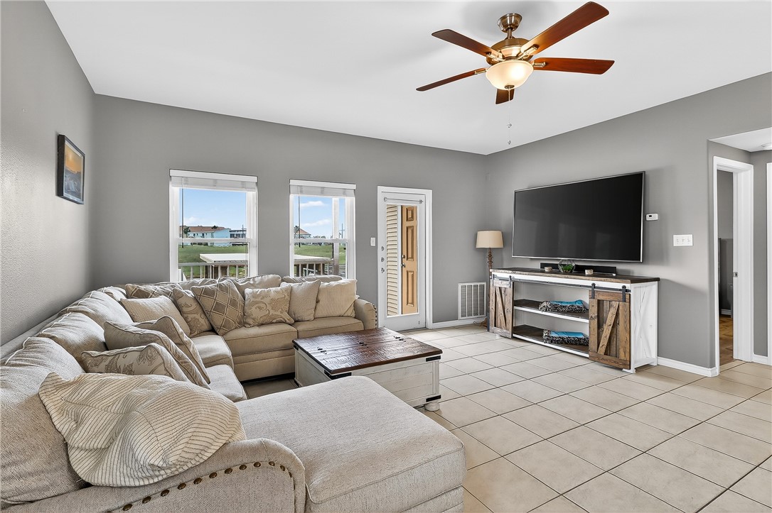 14427 Compass Street, Unit A6 Corpus Christi, TX 78418 - Photo 10 of 40 a living room with furniture and a flat screen tv
