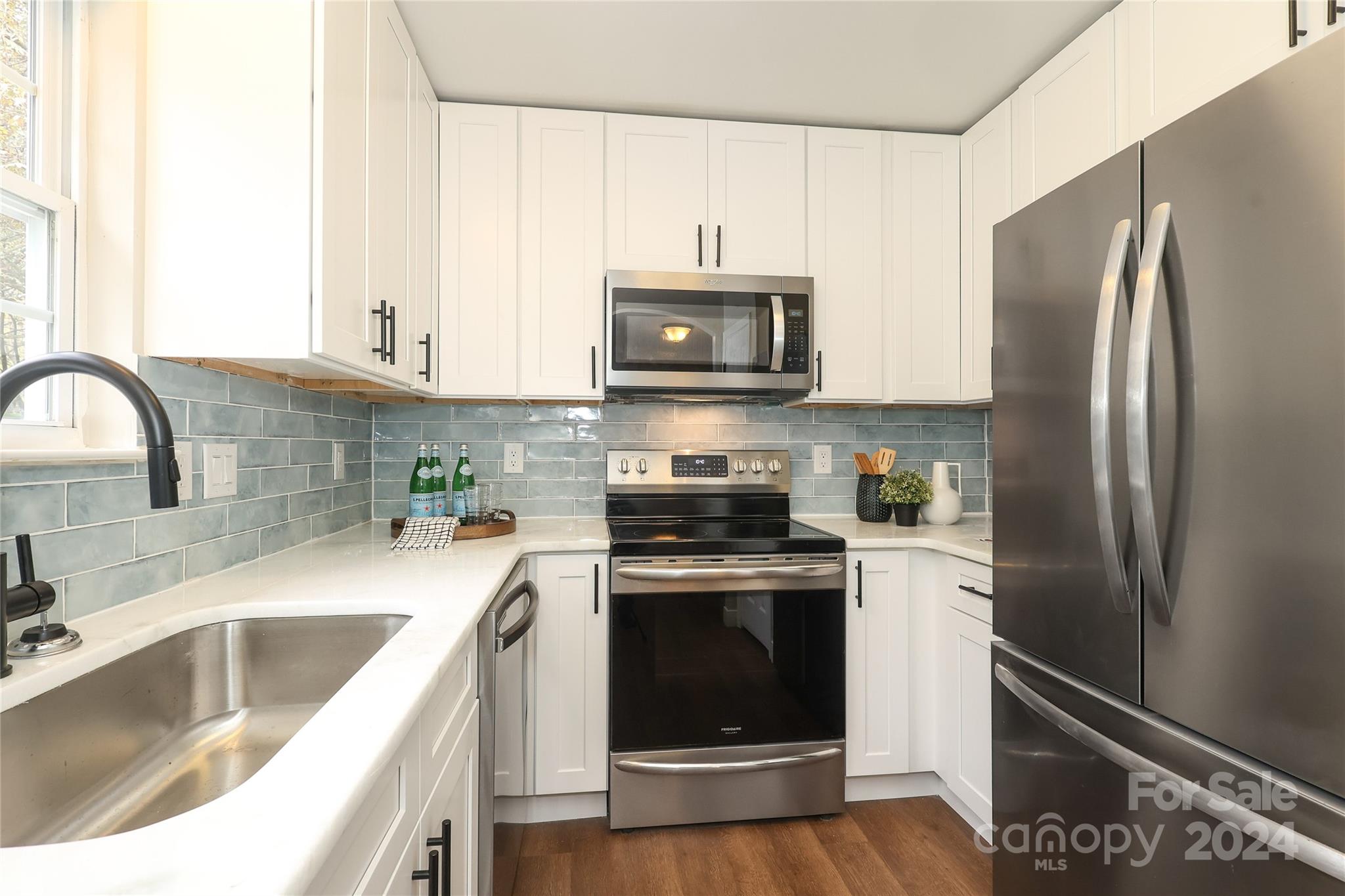 437 Radio Road Charlotte, NC 28216 - Photo 11 of 30 a kitchen with stainless steel appliances granite countertop a refrigerator sink and stove