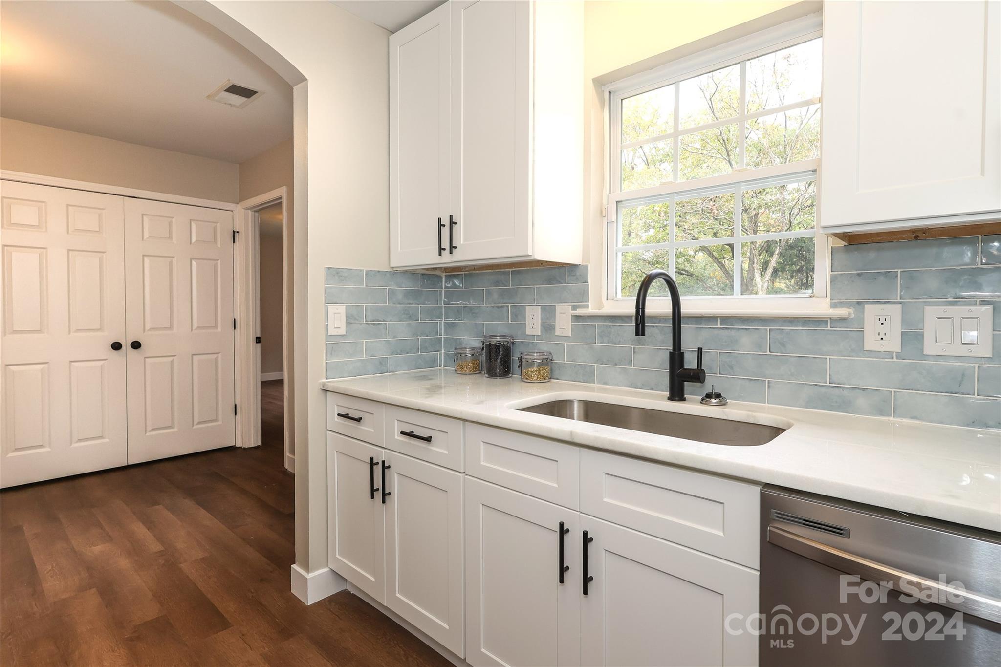 437 Radio Road Charlotte, NC 28216 - Photo 13 of 30 a kitchen with granite countertop white cabinets and a sink