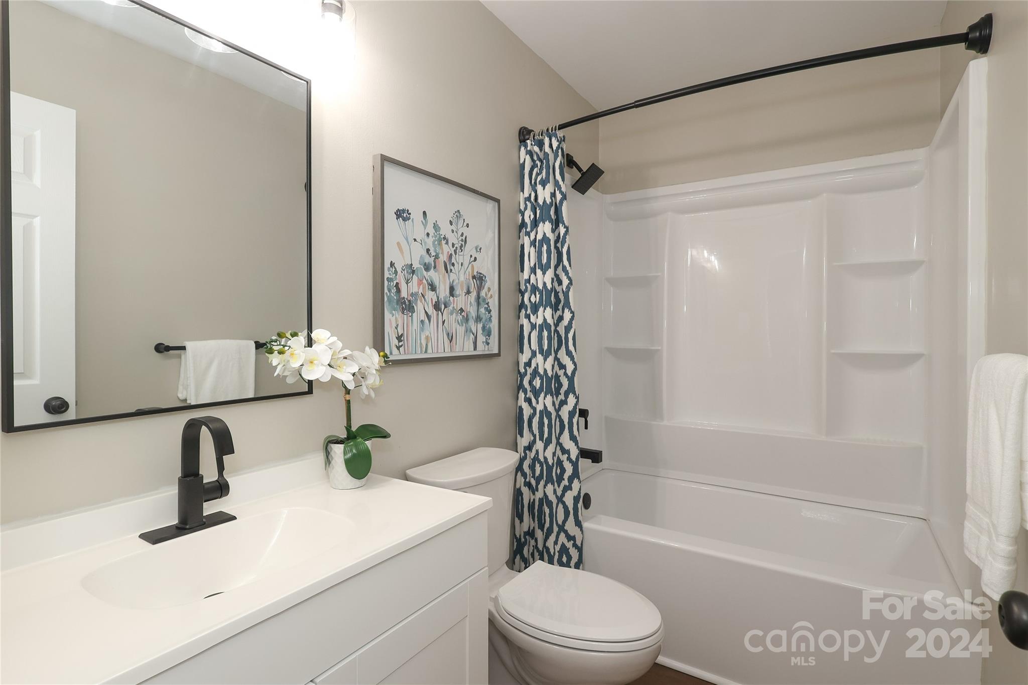 437 Radio Road Charlotte, NC 28216 - Photo 17 of 30 a bathroom with a sink a toilet and shower