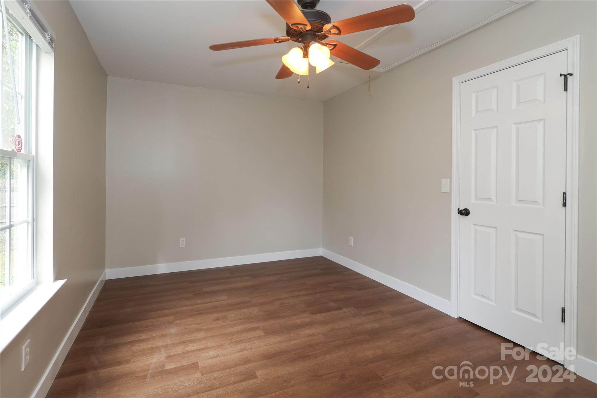 437 Radio Road Charlotte, NC 28216 - Photo 19 of 30 wooden floor in an empty room with a window