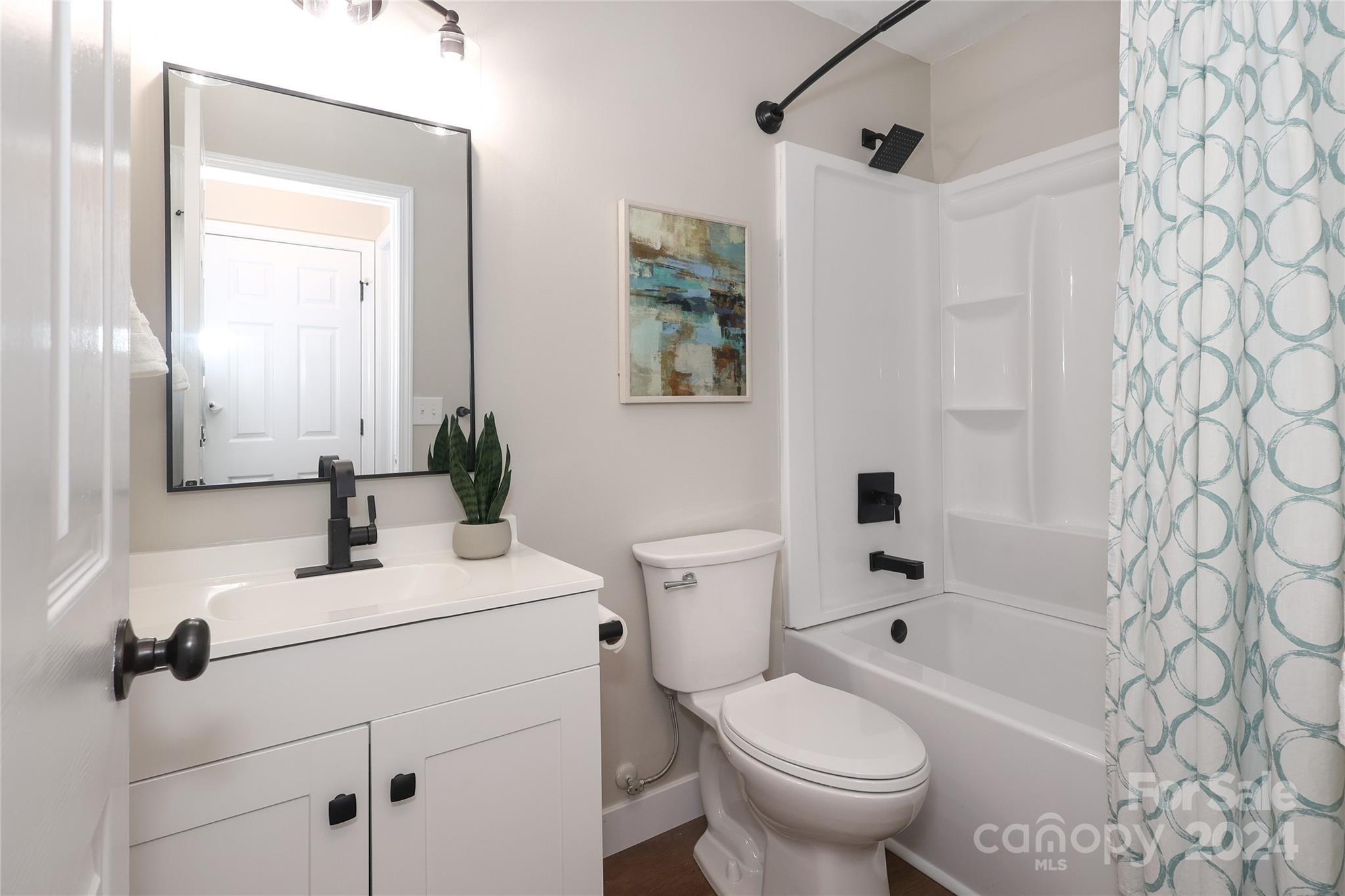 437 Radio Road Charlotte, NC 28216 - Photo 20 of 30 a bathroom with a sink toilet and shower