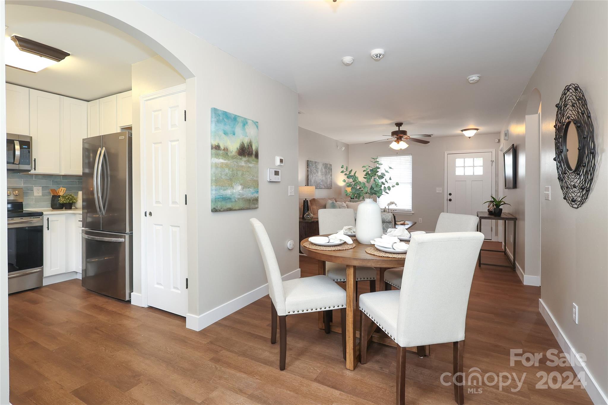 437 Radio Road Charlotte, NC 28216 - Photo 9 of 30 a dining room with furniture a kitchen and chandelier
