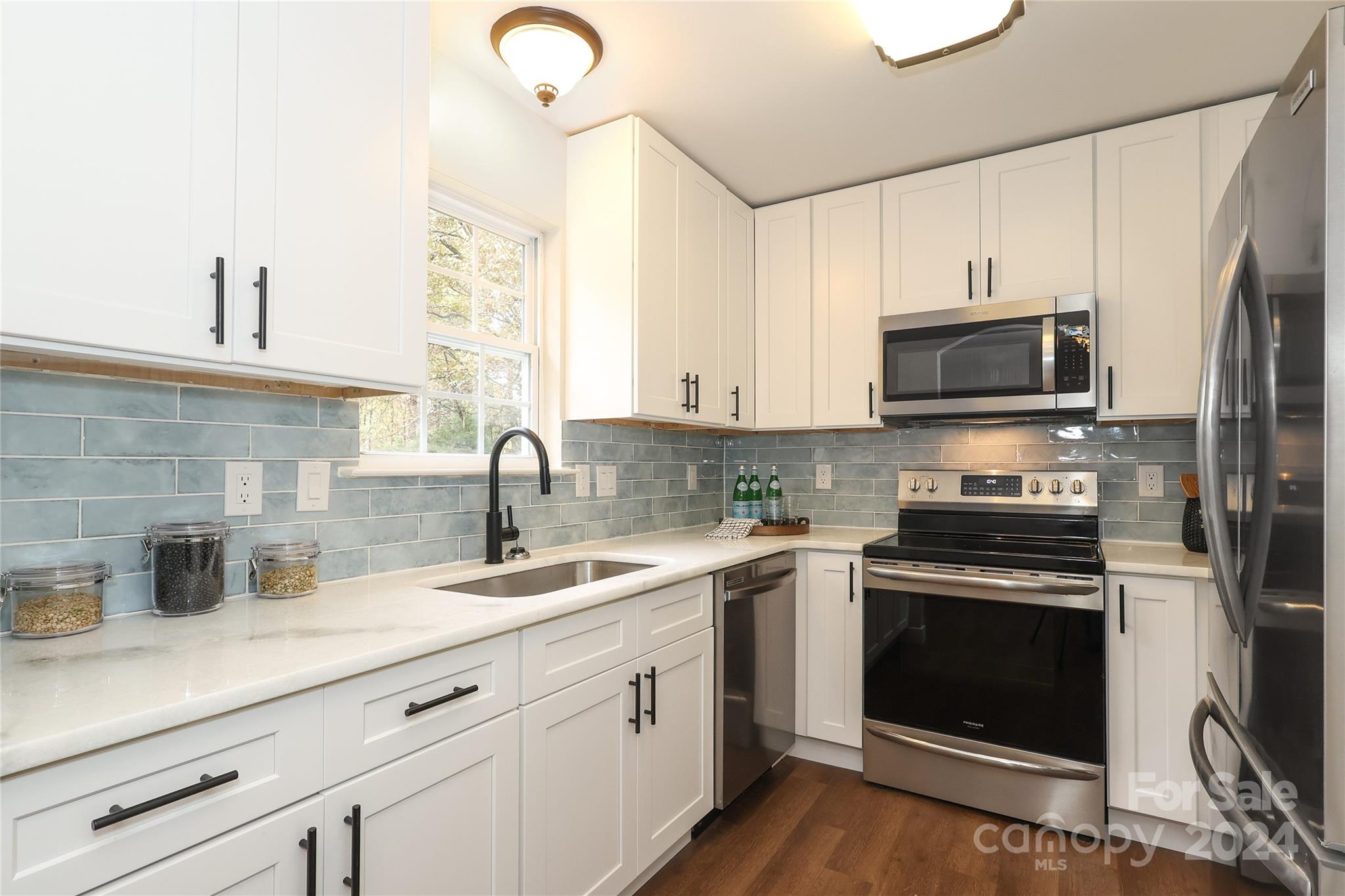 437 Radio Road Charlotte, NC 28216 - Photo 10 of 30 a kitchen with a sink stove and microwave