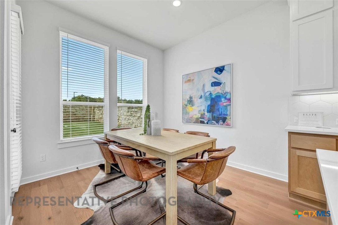 148 Spanish Oak Castroville, TX 78009 - Photo 13 of 20 a view of a dining room with furniture wooden floor and a window