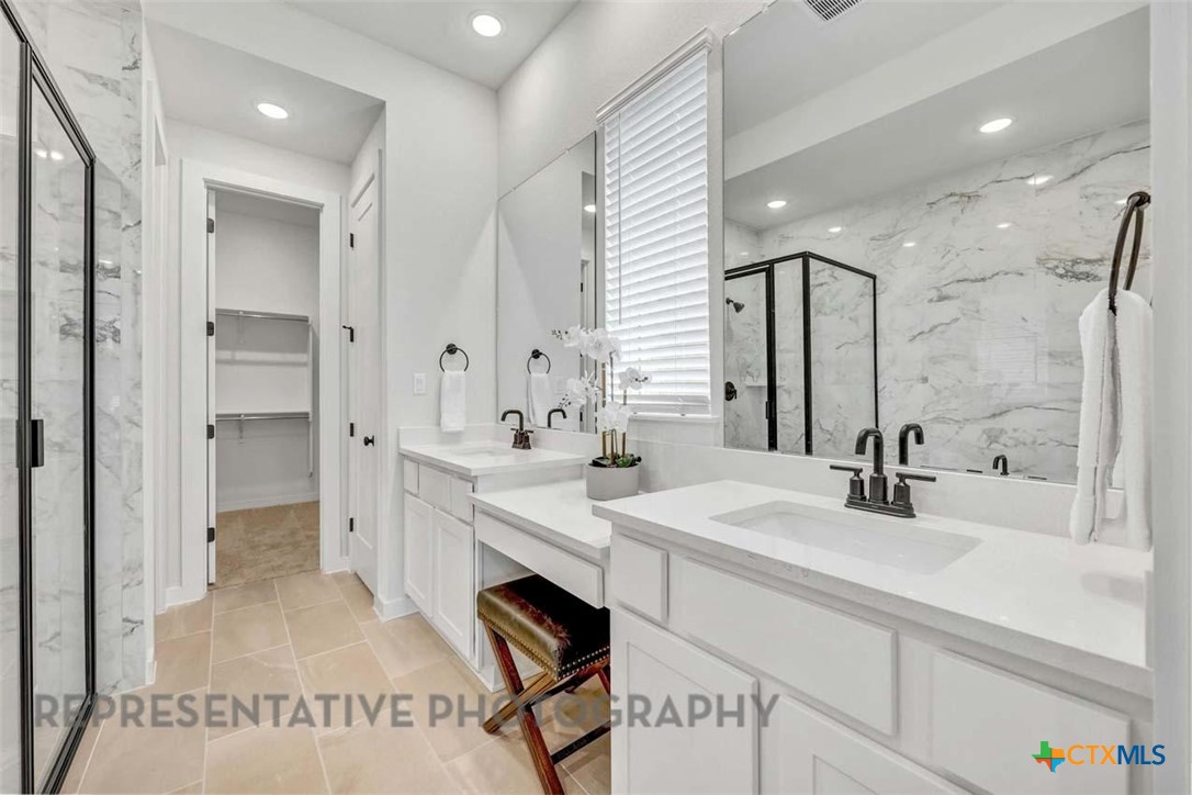 148 Spanish Oak Castroville, TX 78009 - Photo 14 of 20 a bathroom with a sink double vanity and a mirror