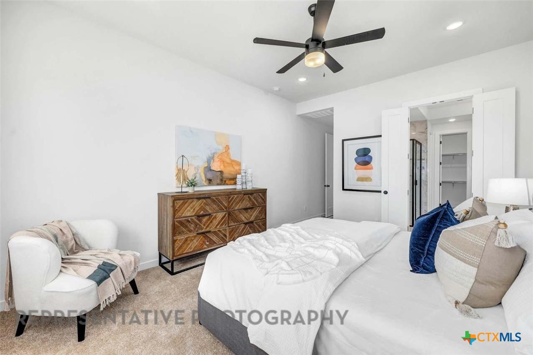 148 Spanish Oak Castroville, TX 78009 - Photo 10 of 20 a bedroom with a bed and couch