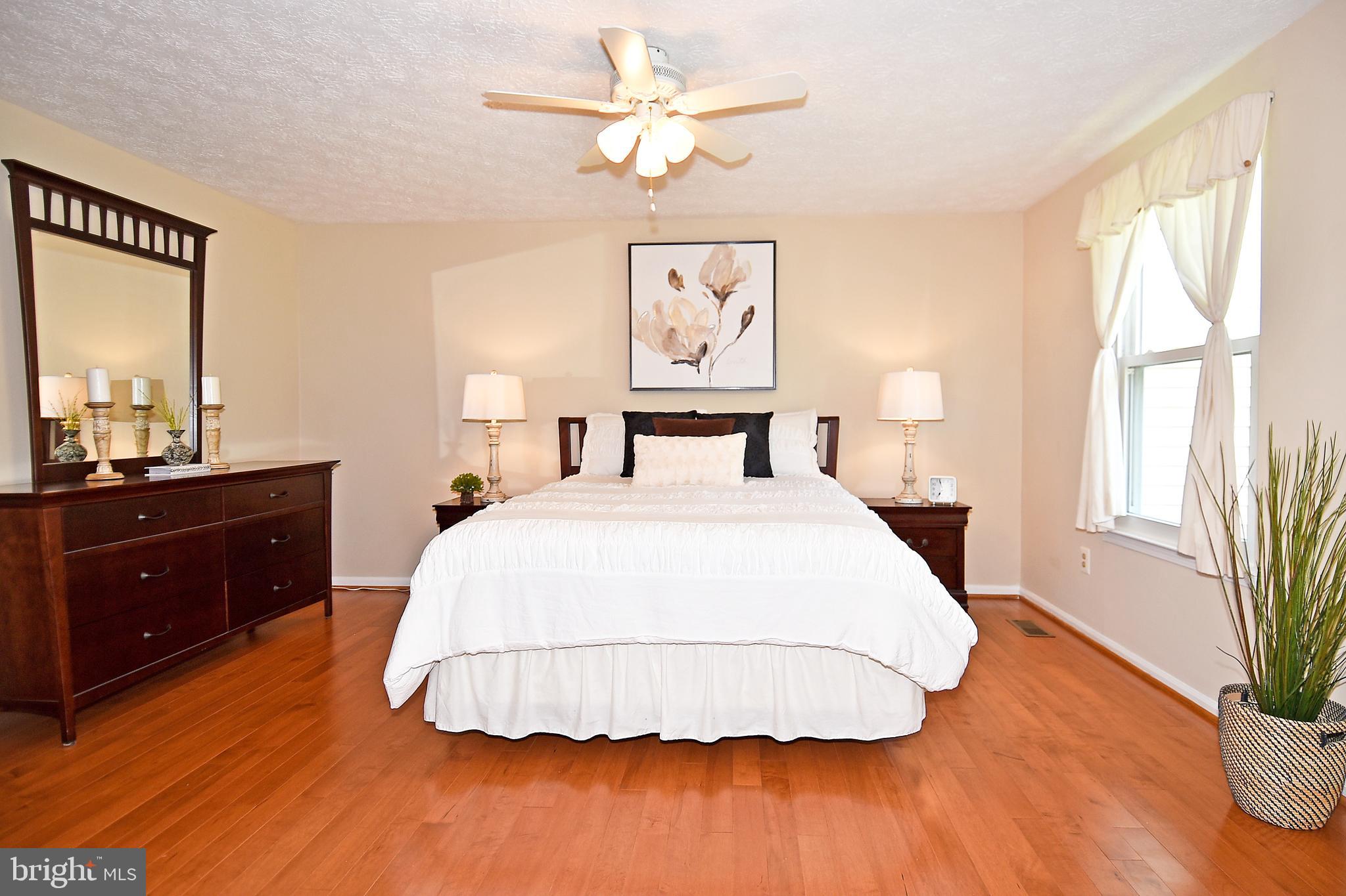 6591 Forest Dew Court Springfield, VA 22152 - Photo 18 of 39 Light-filled master bedroom w/ hardwood floors