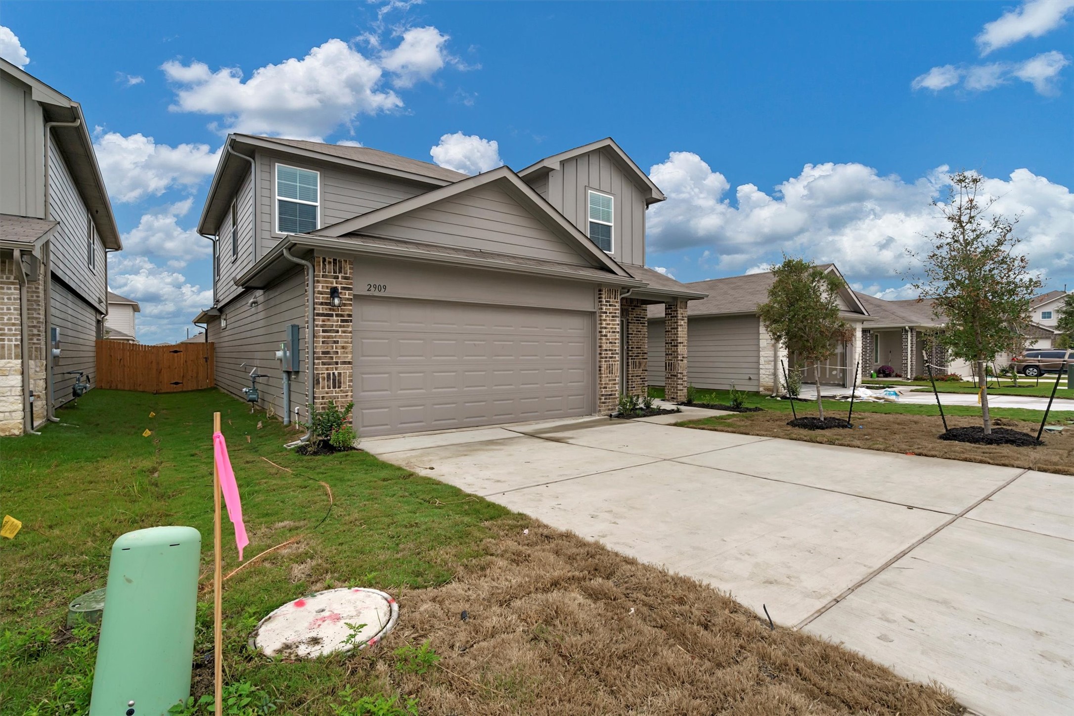 2909 Tweedy Trail Pflugerville, TX 78660 - Photo 3 of 27 A newly constructed residence features a spacious driveway and attached garage.
