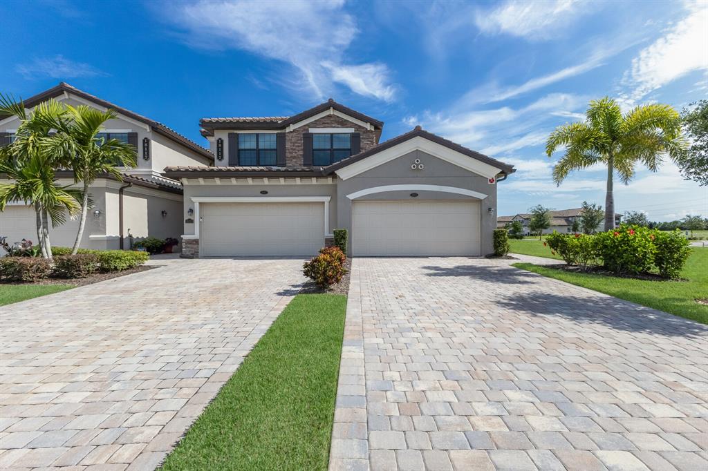 18117 Gawthrop Drive, Unit 104 Bradenton, FL 34211 - Photo 1 of 54 a front view of a house with a garden and yard