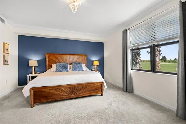 a bedroom with a bed and window