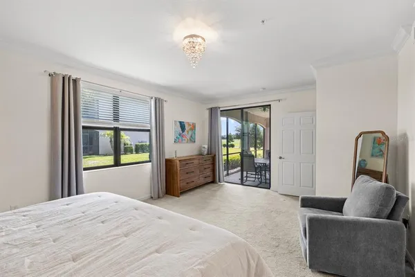 a bedroom with bed and glass window