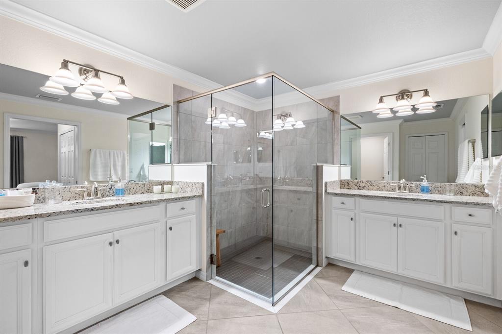 18117 Gawthrop Drive, Unit 104 Bradenton, FL 34211 - Photo 19 of 54 a bathroom with a granite countertop sink a mirror and a shower