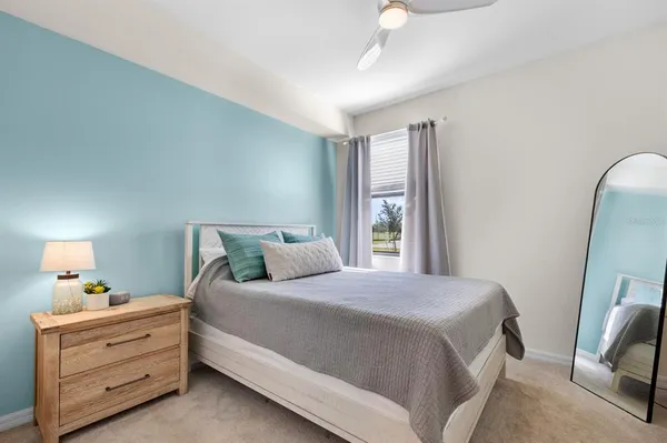 a bedroom with a bed and a mirror